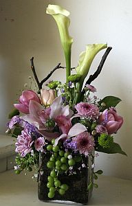 Corporate arrangement made of orhids cymbidium, mauve santini, white calla-lily and pink tulips